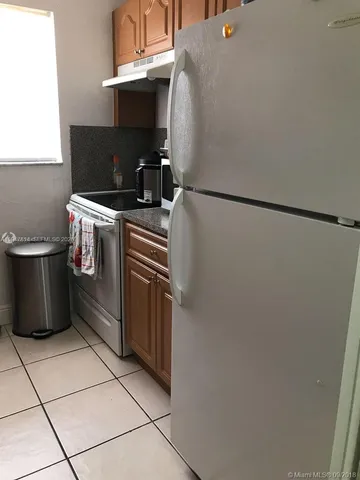 a kitchen with a stove and a refrigerator