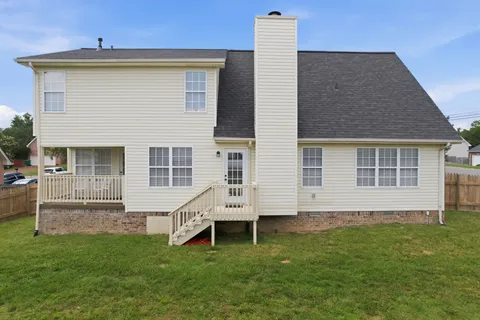 a view of house with backyard
