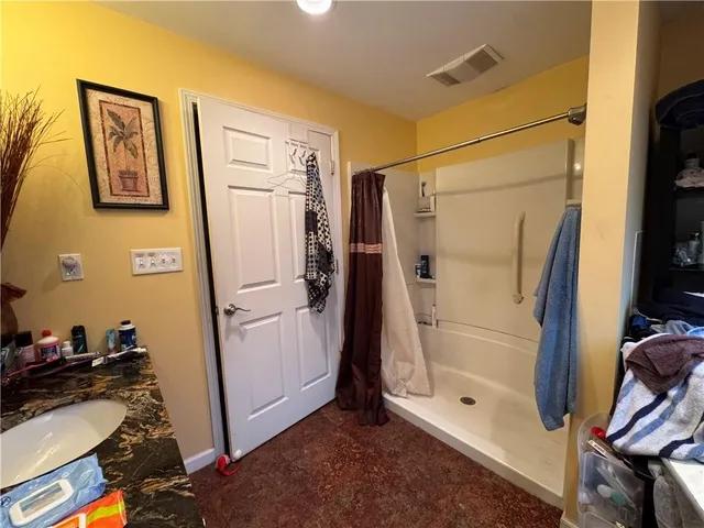 a bathroom with a shower and a mirror