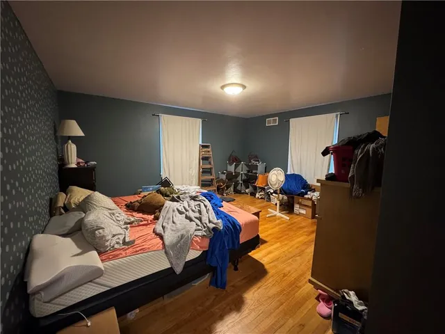 a bed room with a bed and a chair