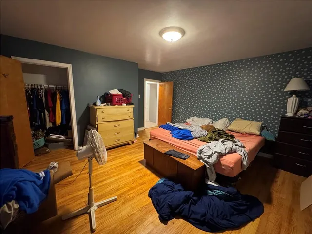 a bed room with furniture and a mirror