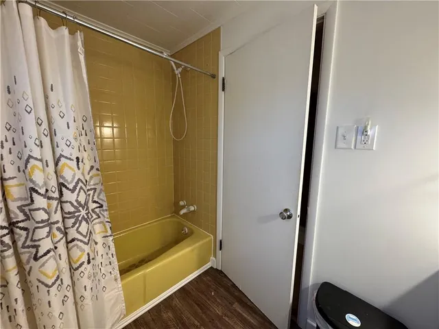 a bathroom with a shower and a tub