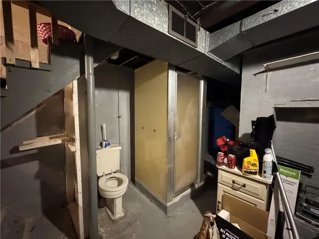 a view of a hallway with wooden floor and furniture