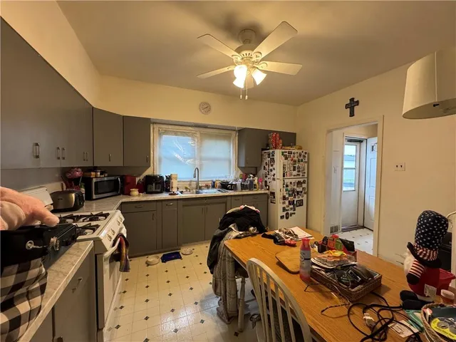 a kitchen with a sink stove and refrigerator