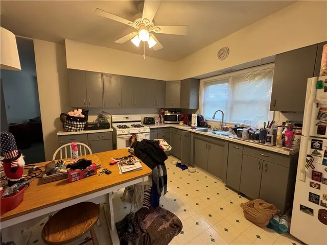 a kitchen that has a lot of cabinets a sink and a stove
