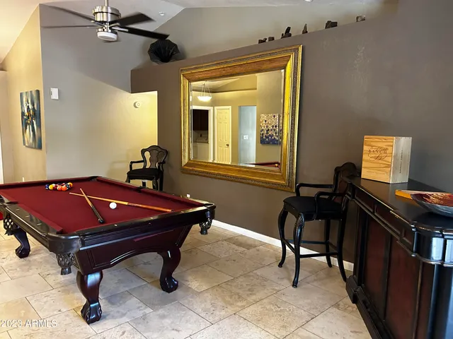 a kitchen with stainless steel appliances kitchen island granite countertop a sink a stove a microwave a refrigerator and a microwave