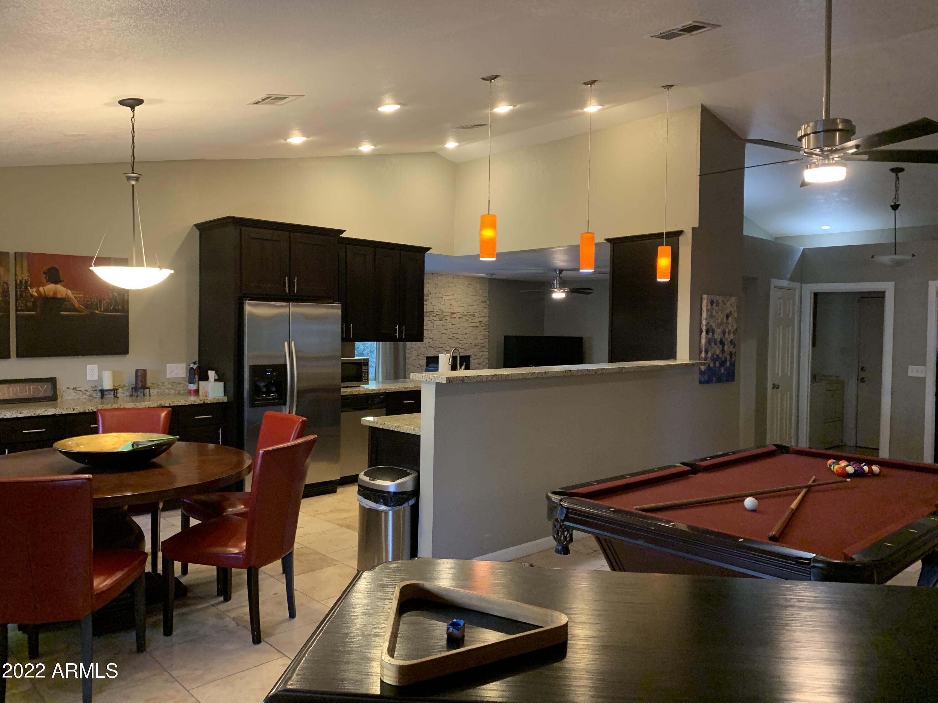 6002 East Beck Lane Scottsdale, AZ 85254 - Photo 15 of 35 a kitchen with stainless steel appliances kitchen island granite countertop a sink a stove a microwave a refrigerator and a microwave