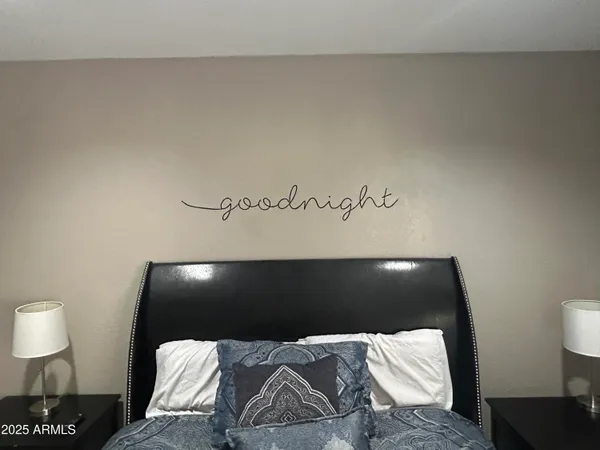 a bed room with a bed and a television