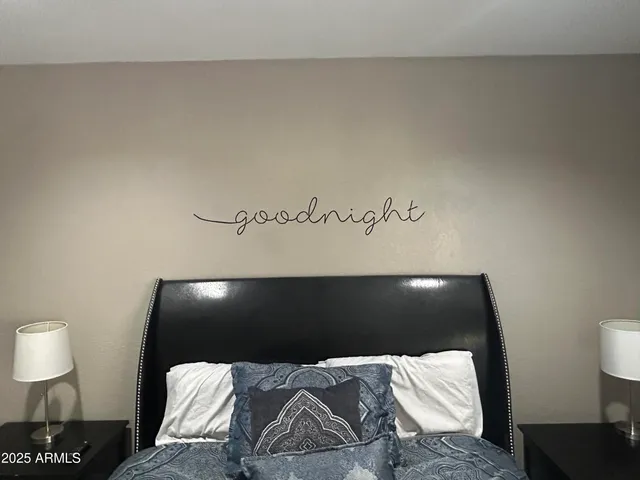 a bed room with a bed and a television