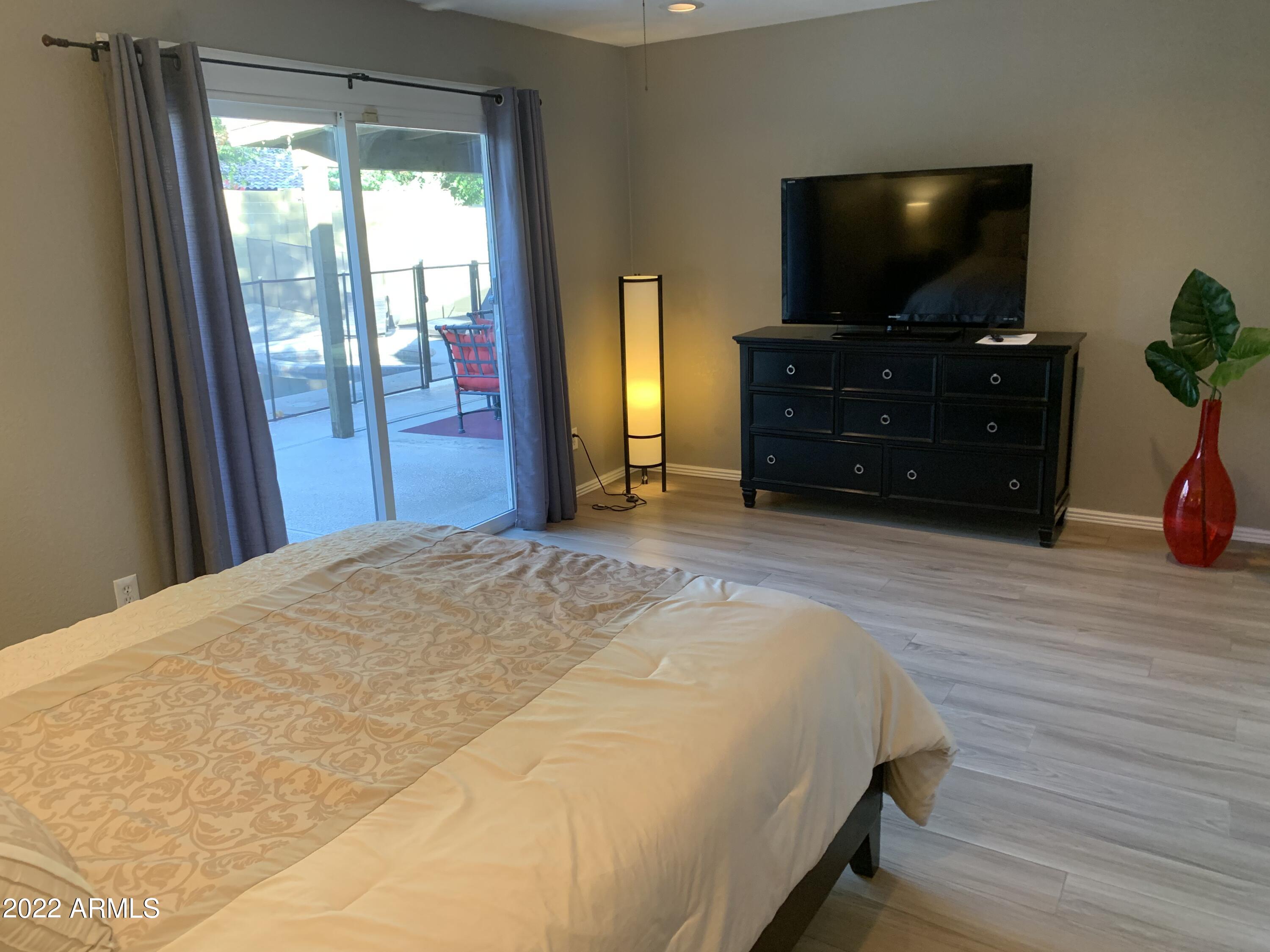 6002 East Beck Lane Scottsdale, AZ 85254 - Photo 18 of 35 a bed room with a bed and a television