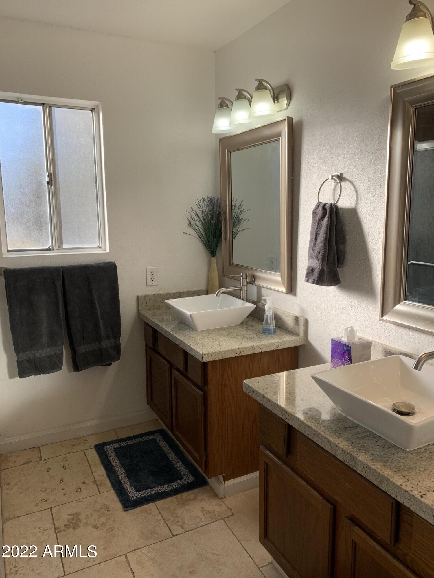 6002 East Beck Lane Scottsdale, AZ 85254 - Photo 19 of 35 a bathroom with a sink and a mirror