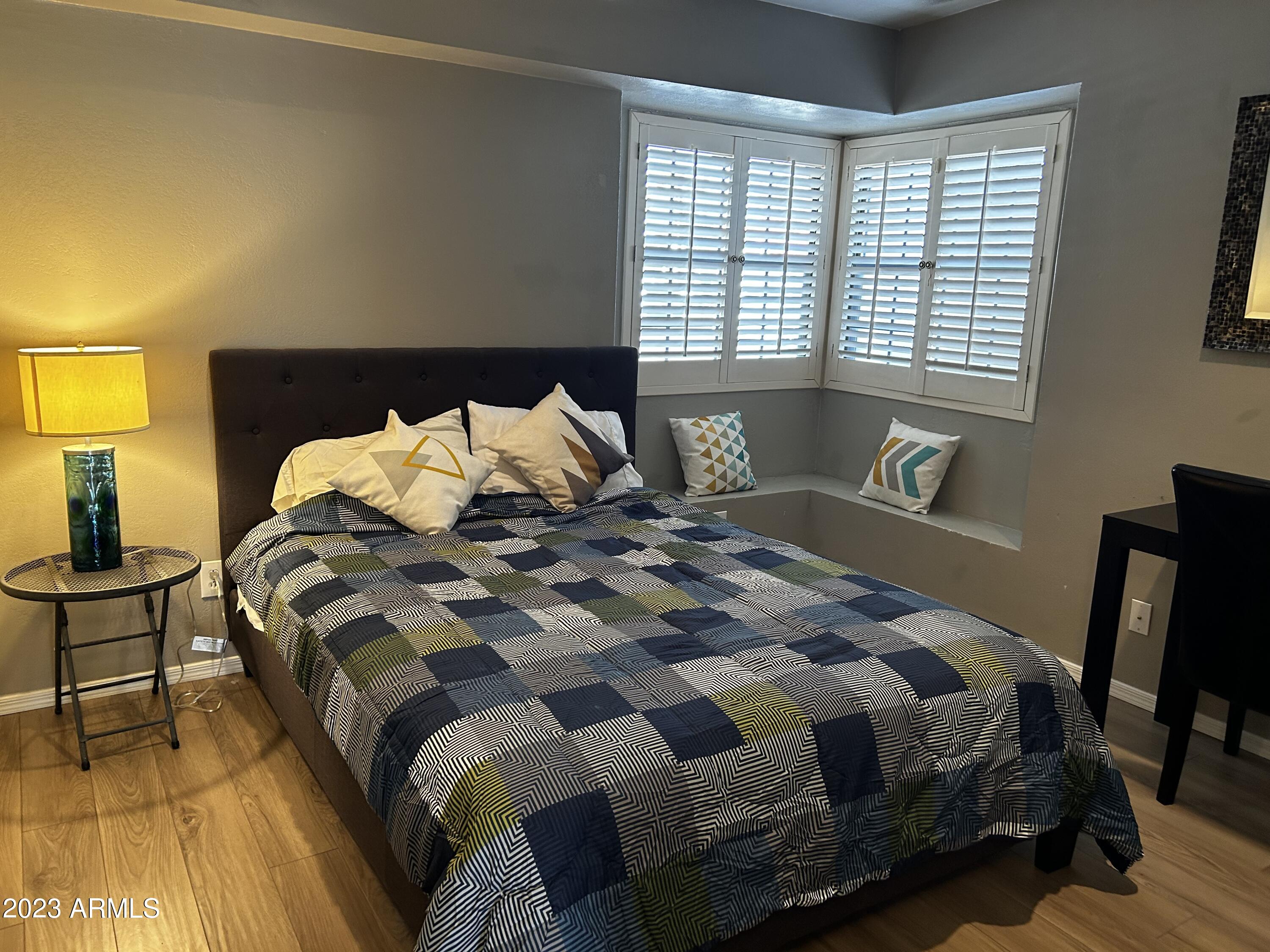 6002 East Beck Lane Scottsdale, AZ 85254 - Photo 20 of 35 a bedroom with a bed and wooden floor