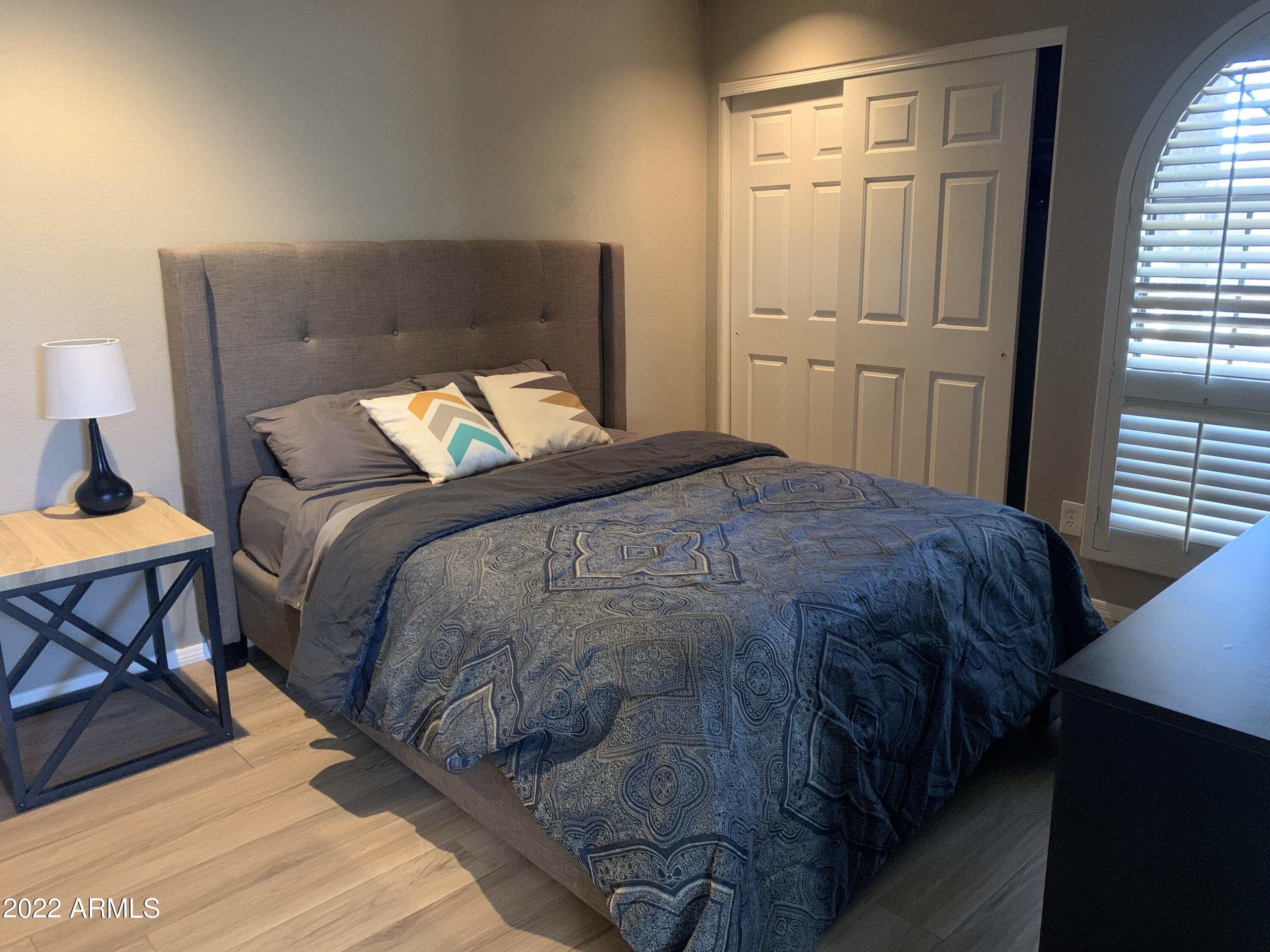 6002 East Beck Lane Scottsdale, AZ 85254 - Photo 22 of 35 a bed sitting in a bedroom next to a window