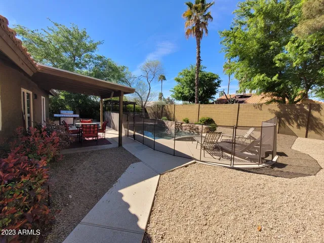 a view of a backyard with sitting area