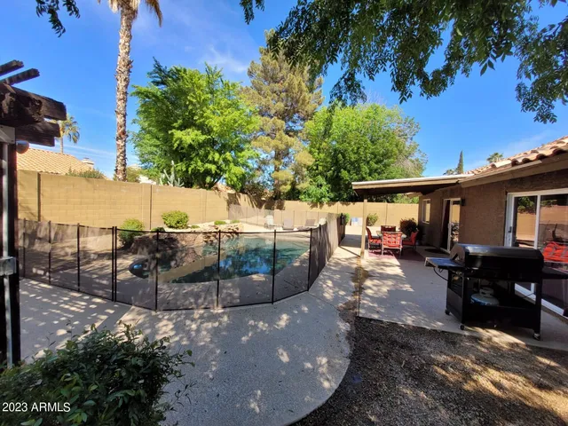 a view of a backyard with sitting area