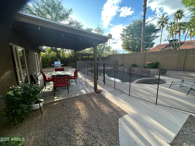 a view of a porch with chairs and a potted plant