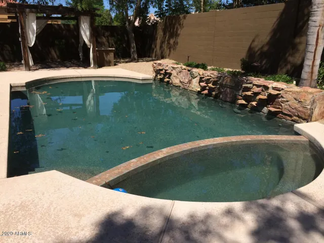 a view of a swimming pool with a patio