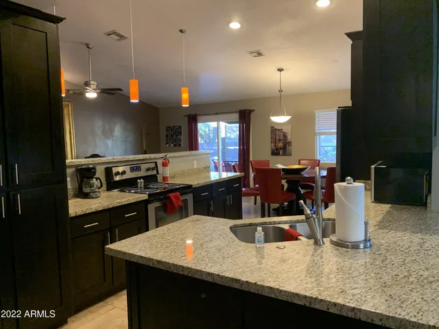 a kitchen with kitchen island a sink appliances and cabinets