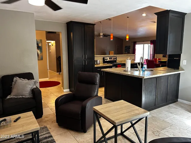 a kitchen with a table chairs and a refrigerator