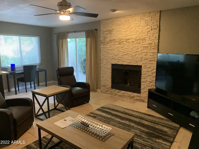 a living room with furniture and a fireplace