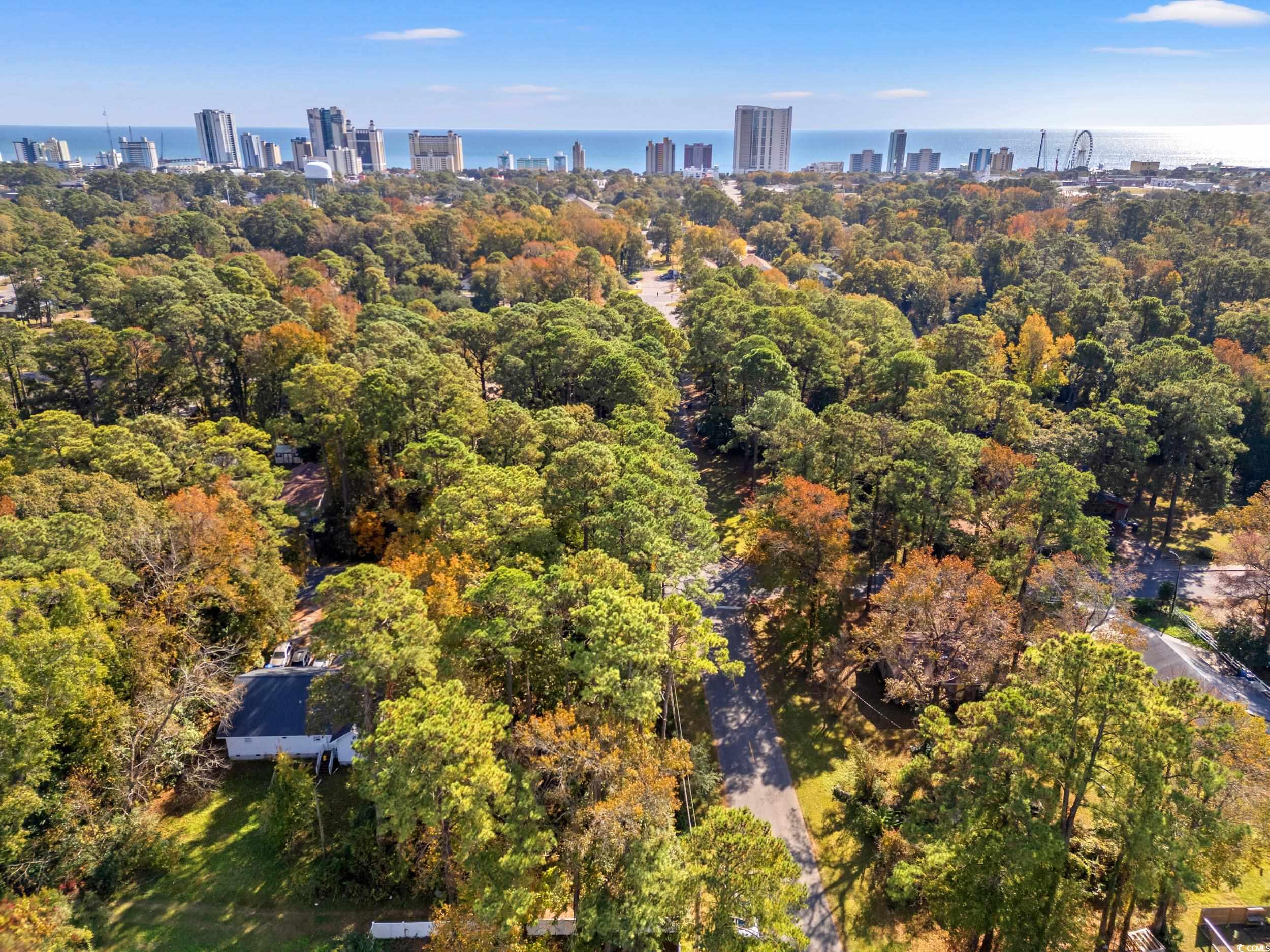 Aerial view of property's location with city skyline and a large body of water