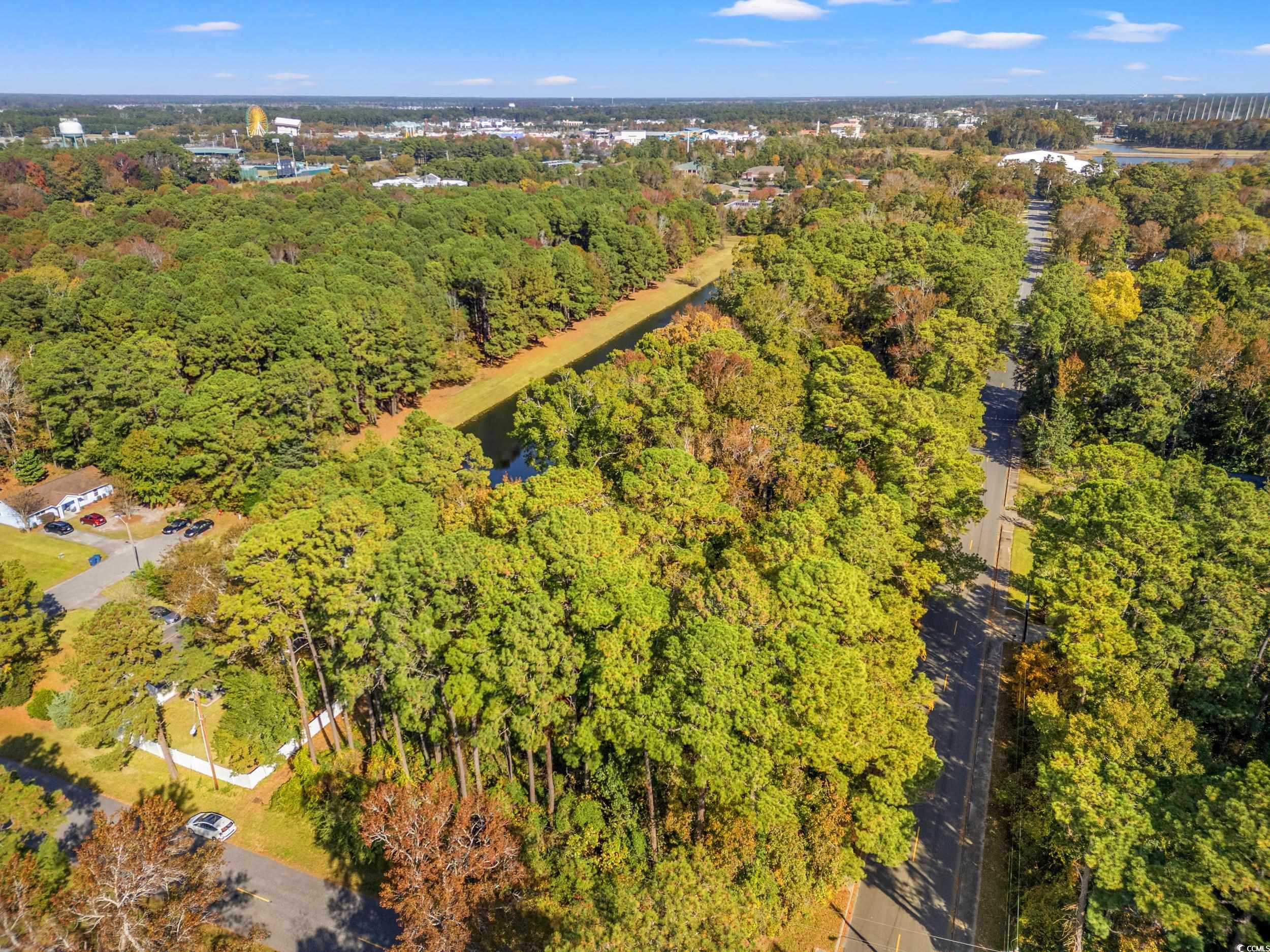 1301 King Street Myrtle Beach, SC 29577 - Photo 11 of 11 Aerial view of property and surrounding area featuring a heavily wooded area