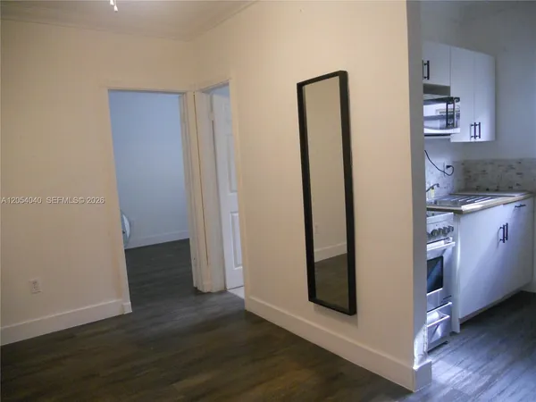 a view of a kitchen with wooden floor and a sink