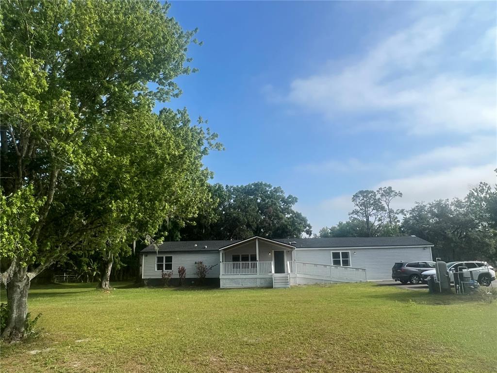 5855 Jack Brack Road St. Cloud, FL 34771 - Photo 42 of 86 a view of a swimming pool with lawn chairs and plants
