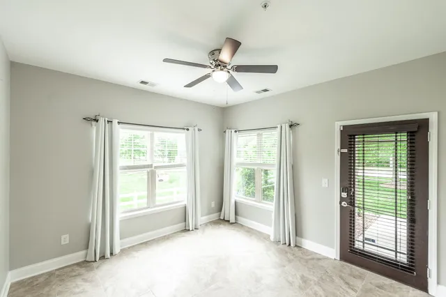 a view of a livingroom with a ceiling fan and window