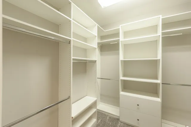 a spacious bathroom with a granite countertop sink mirror and a