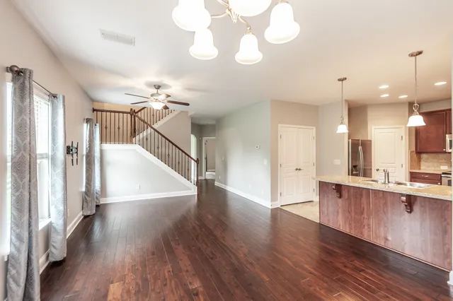 a view of a kitchen with wooden floor and a kitchen