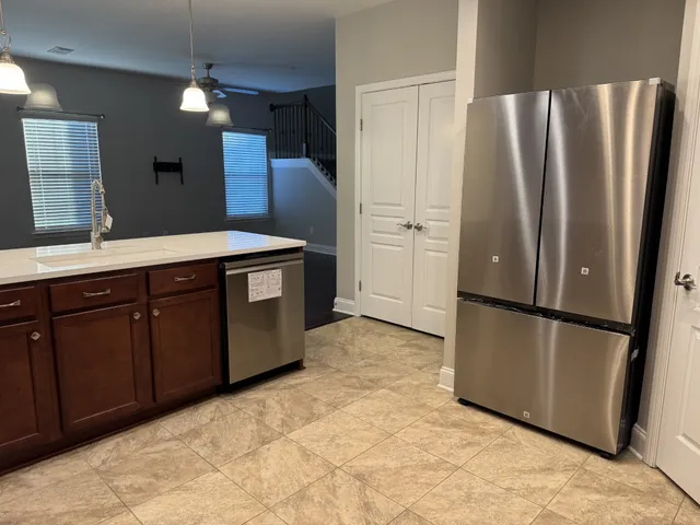 a kitchen with stainless steel appliances a refrigerator and a sink