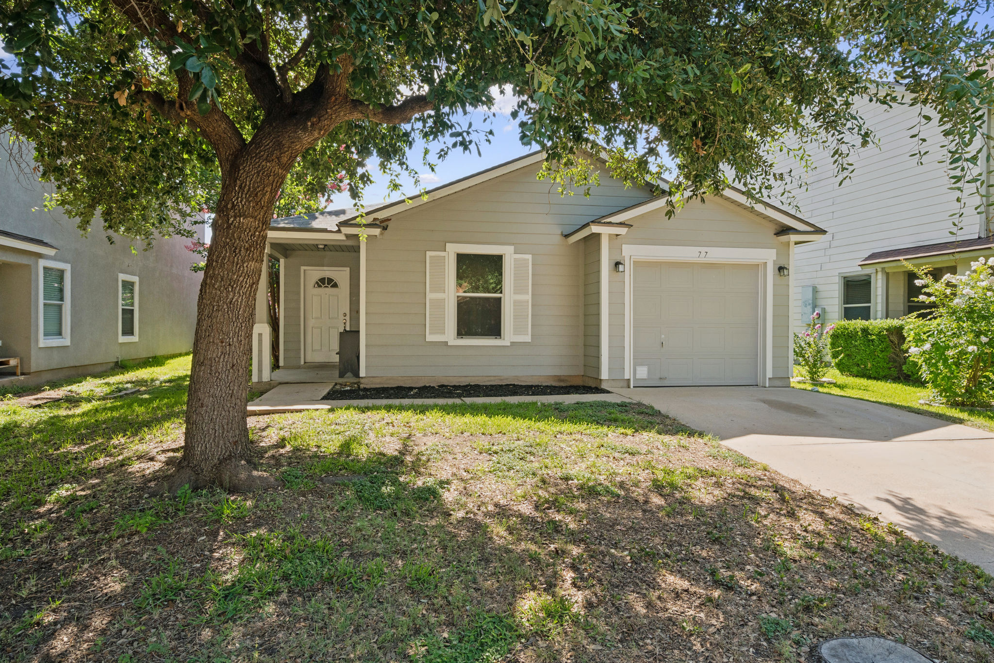 77 Jan Lane Georgetown, TX 78626 - Photo 2 of 16 A welcoming facade showcases a single-story home with a neat driveway and inviting entry.