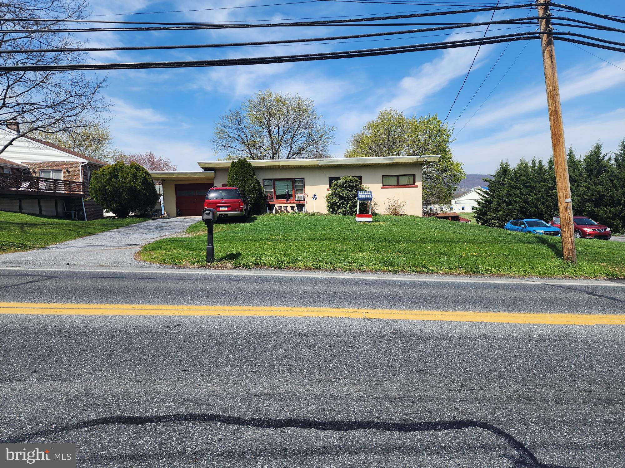 761 Wertzville Road Enola, PA 17025 - Photo 3 of 25 a front view of a house with a yard and garage