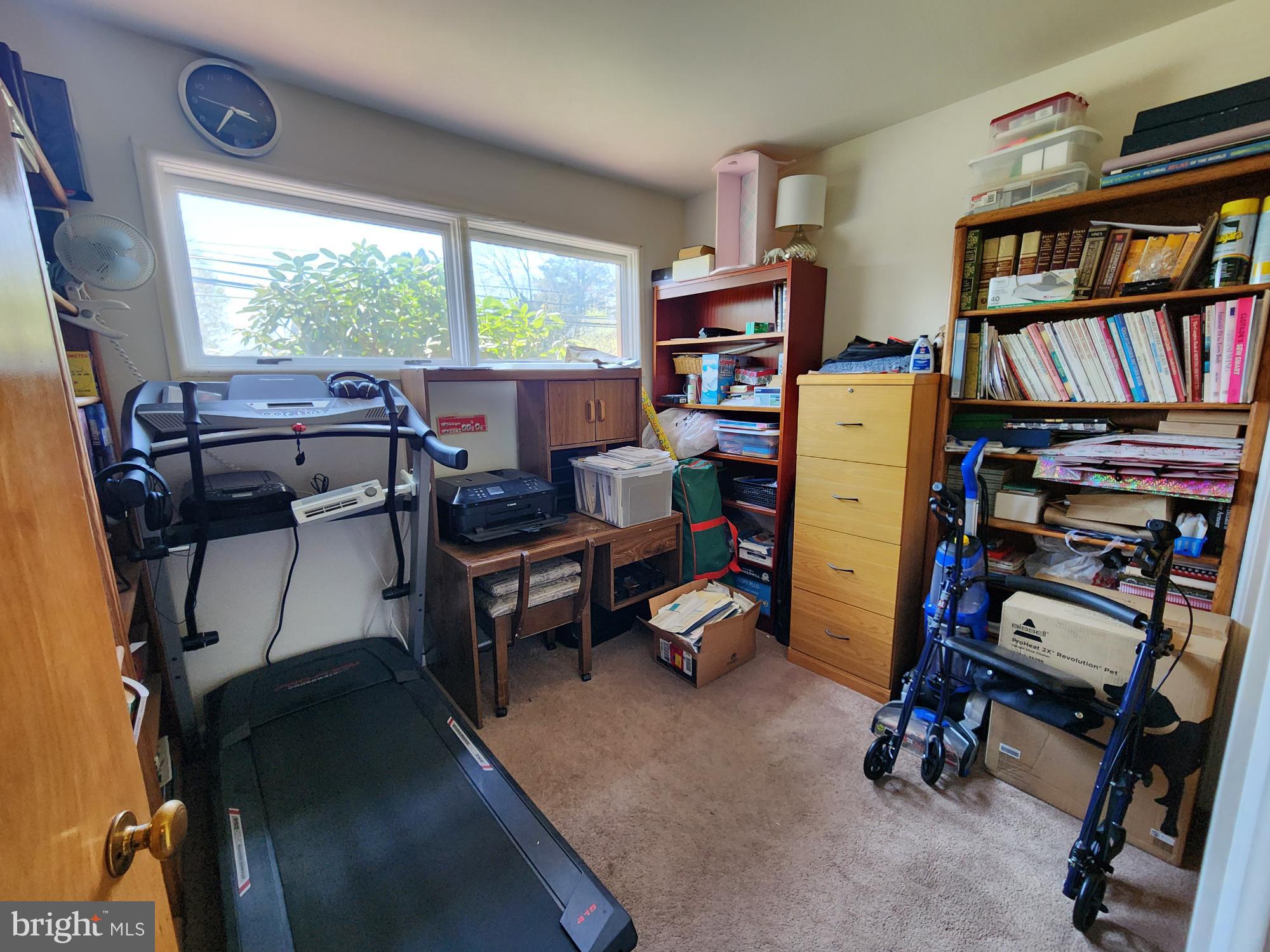 761 Wertzville Road Enola, PA 17025 - Photo 10 of 25 a view of a workspace with furniture and a bookshelf