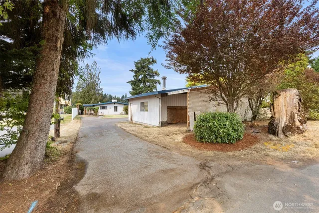 a view of a large house with a large tree