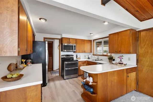 a kitchen with stainless steel appliances granite countertop a sink stove and refrigerator