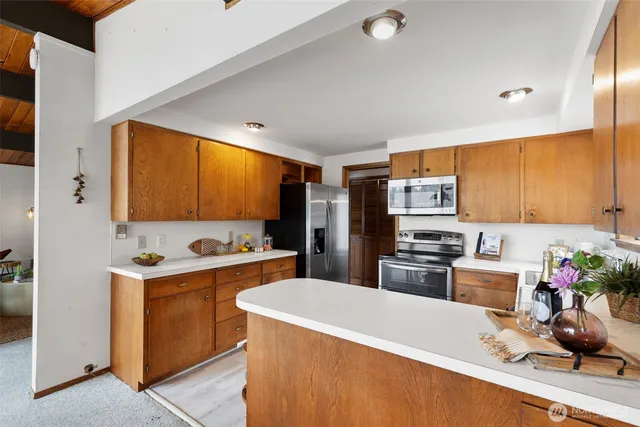 a kitchen that has a sink and a stove in it