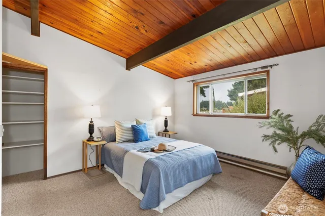 a bedroom with a bed and a potted plant