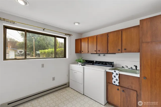 a room with wooden floor and white cabinets