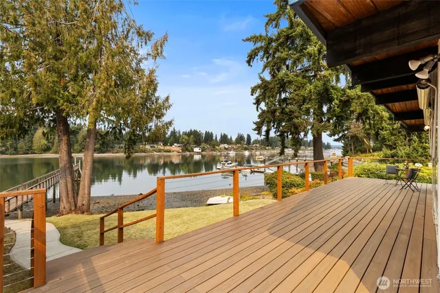 a view of a lake with boats and trees in the background