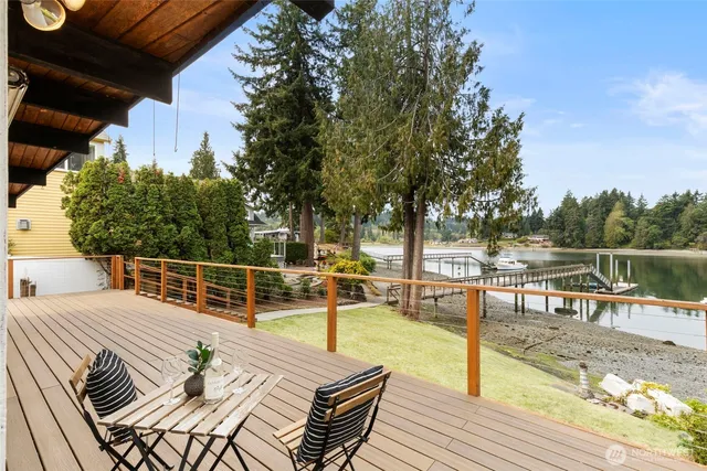 a view of a roof deck with dining table and chairs with wooden floor