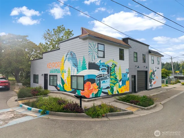 a view of multiple house with a yard and potted plants