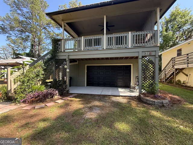 a front view of a house with a yard and a garage