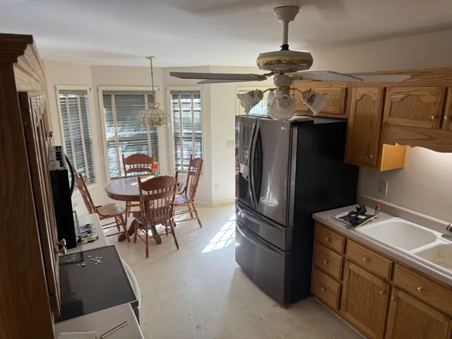 a kitchen with stainless steel appliances a refrigerator a sink a stove and cabinets