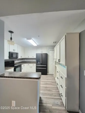 a large kitchen with cabinets