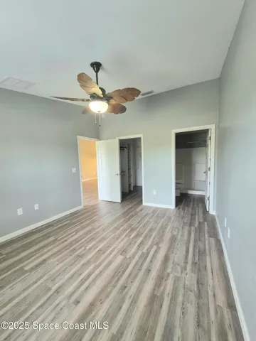 a view of an empty room and wooden floor