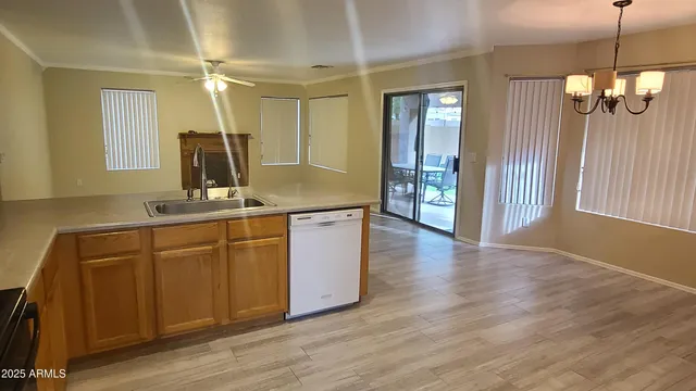 an empty room with wooden floor closet and windows