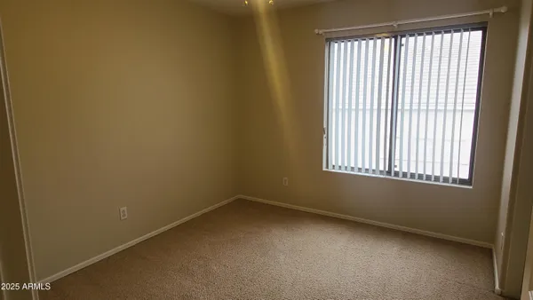 an empty room with closet area