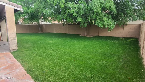 a view of a house with brick walls and a yard